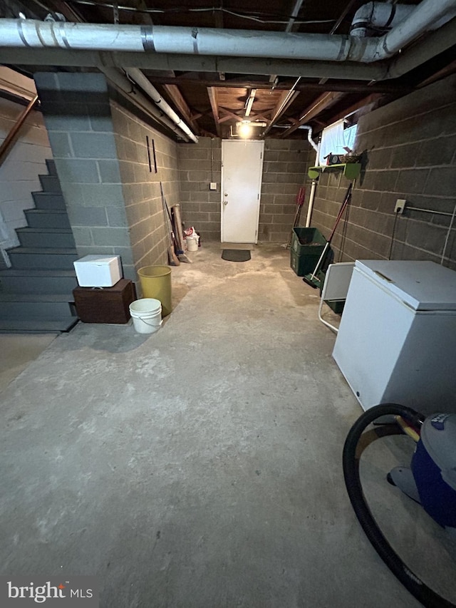 basement with white fridge