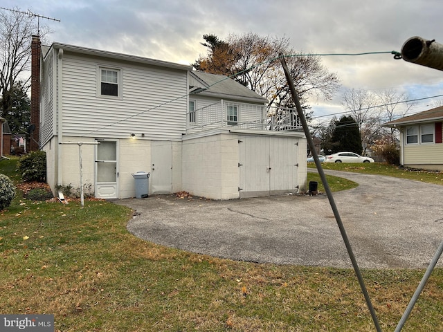 rear view of house with a lawn