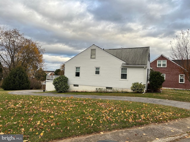 view of side of home featuring a lawn