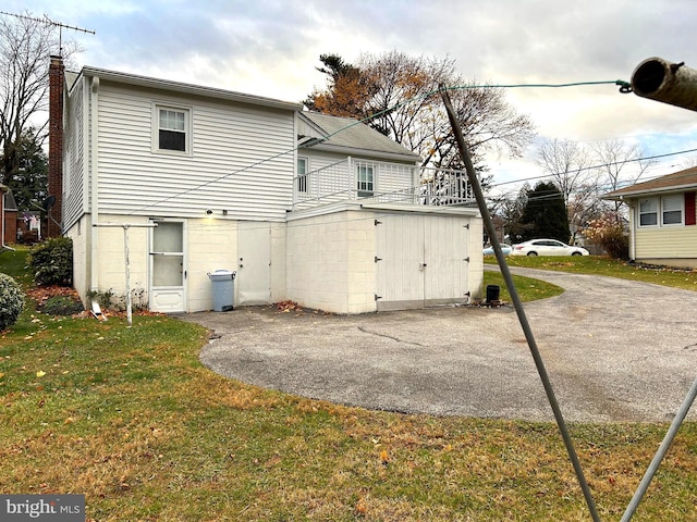 back of property with a lawn