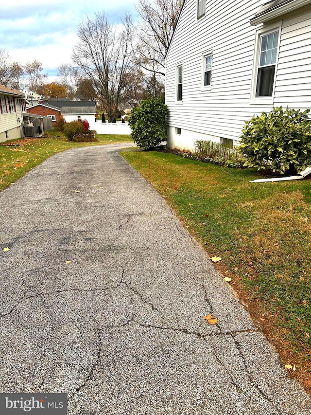 view of property exterior with a lawn