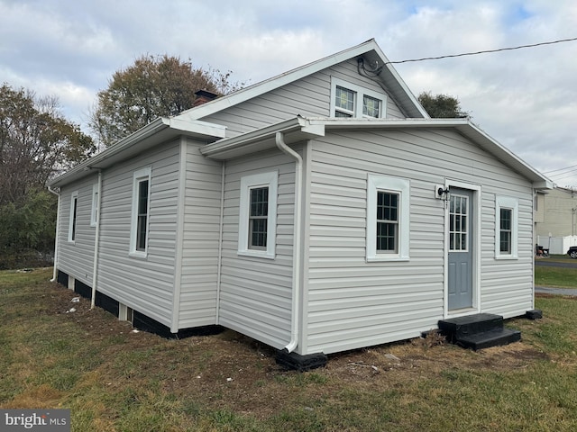 back of property featuring a lawn