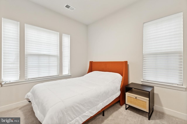 bedroom with light colored carpet