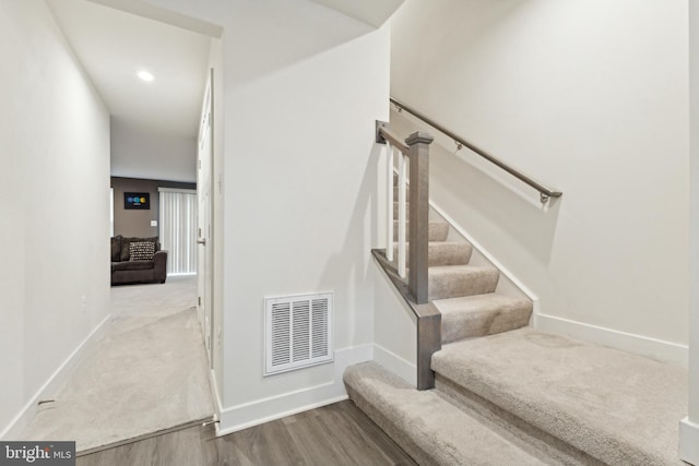 stairway with hardwood / wood-style flooring