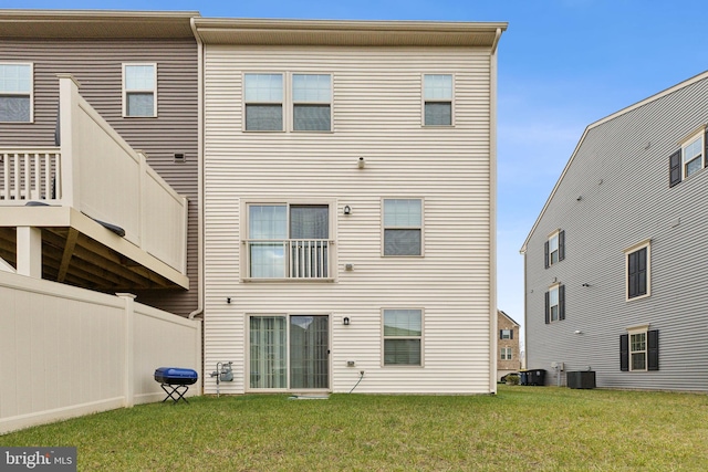 back of house with a yard and central AC unit