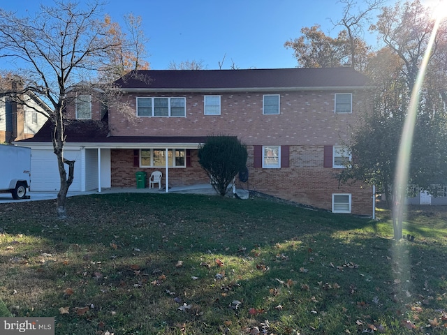 townhome / multi-family property featuring a patio area, a front lawn, and a garage