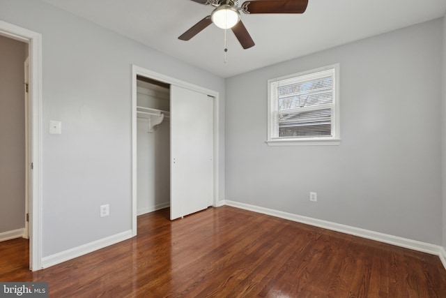 unfurnished bedroom with ceiling fan and dark wood-type flooring