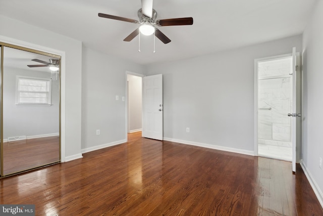 unfurnished bedroom featuring ceiling fan and dark wood-type flooring