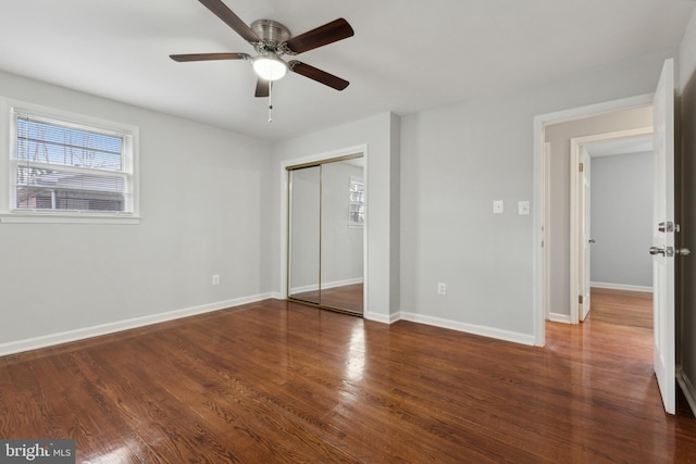 unfurnished bedroom with a closet, ceiling fan, and dark hardwood / wood-style flooring