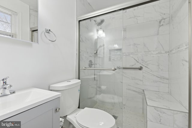 bathroom with vanity, toilet, and a shower with shower door