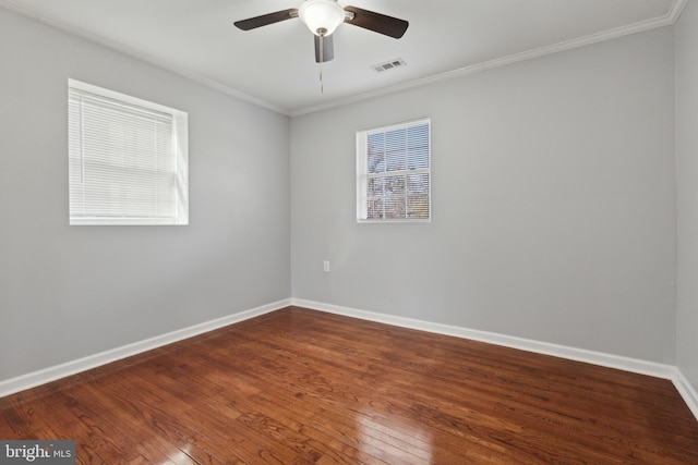 spare room with hardwood / wood-style floors, plenty of natural light, ornamental molding, and ceiling fan