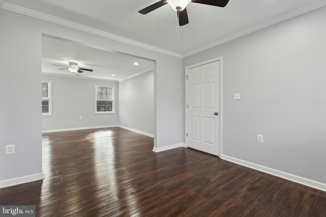 empty room with ceiling fan, dark wood-type flooring, and ornamental molding