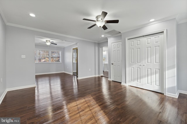 interior space featuring ceiling fan, dark wood-type flooring, two closets, and ornamental molding