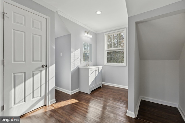 bathroom with crown molding, vanity, wood-type flooring, and lofted ceiling