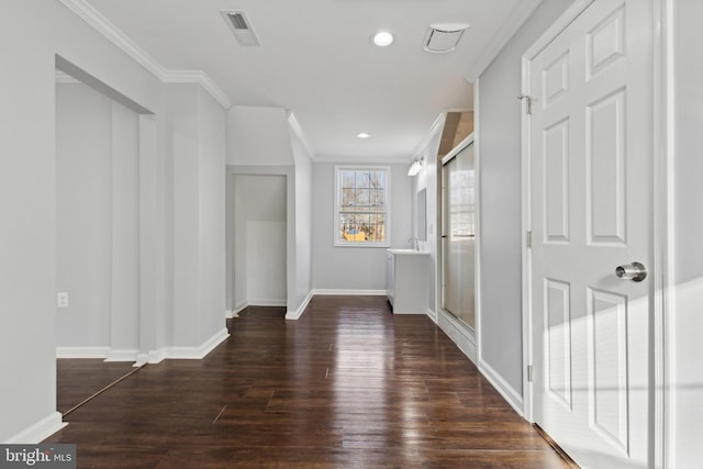 corridor with dark hardwood / wood-style floors and crown molding