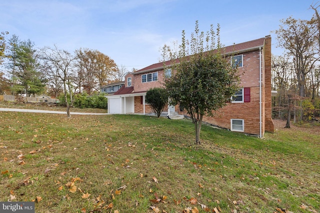 view of front of property featuring a garage and a front yard