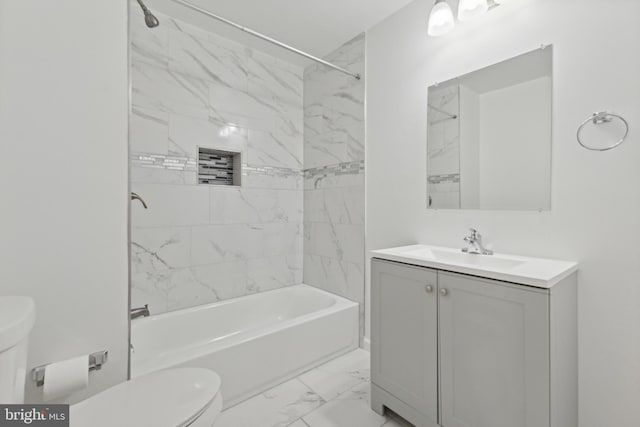 full bathroom with vanity, toilet, and tiled shower / bath