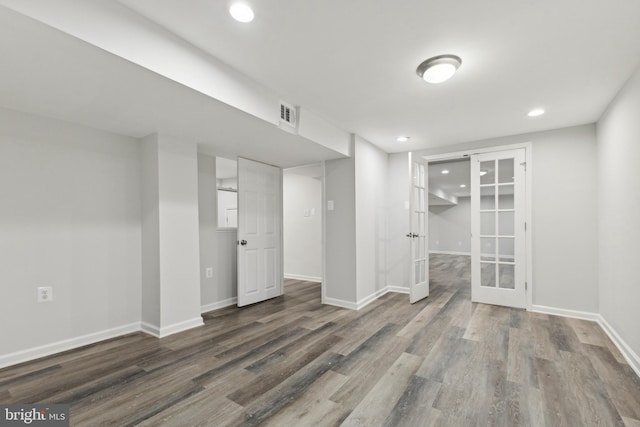 unfurnished room featuring french doors and wood-type flooring