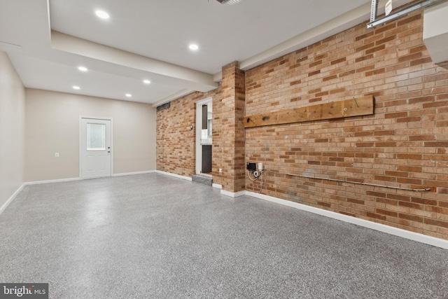 unfurnished living room with brick wall