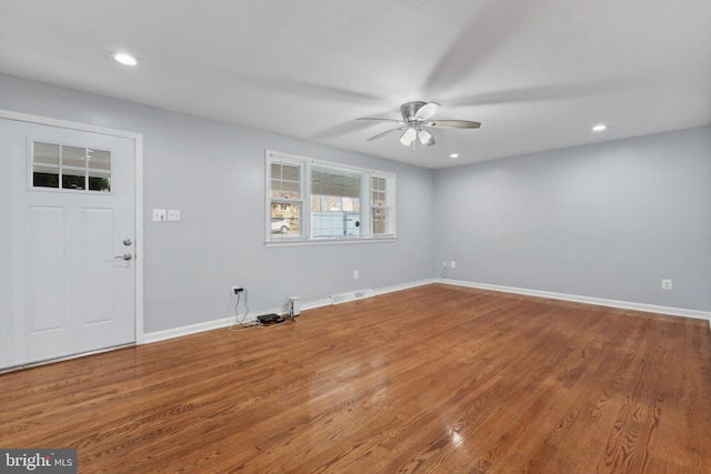 foyer entrance with ceiling fan and wood-type flooring