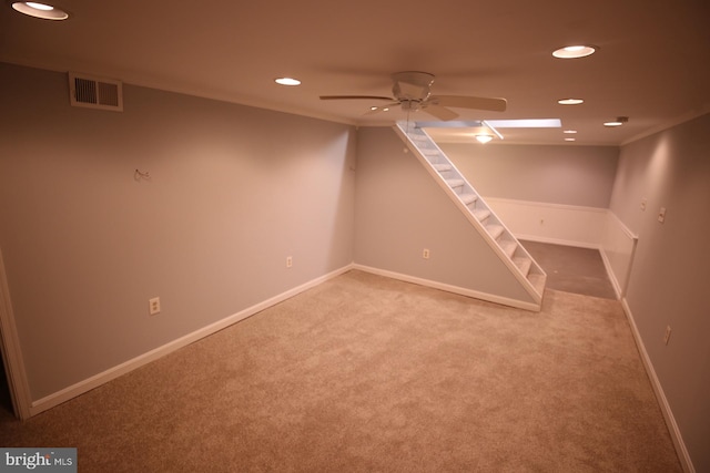 basement with carpet and ceiling fan