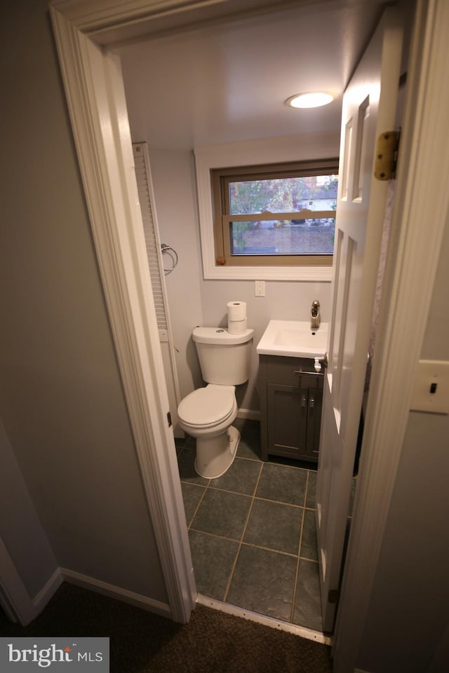 bathroom with tile patterned floors, vanity, and toilet