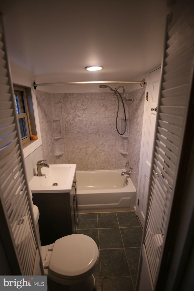 full bathroom featuring toilet, vanity, tile patterned floors, and tiled shower / bath combo