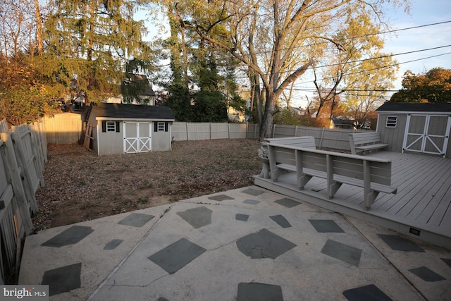 view of yard featuring a deck and a storage shed