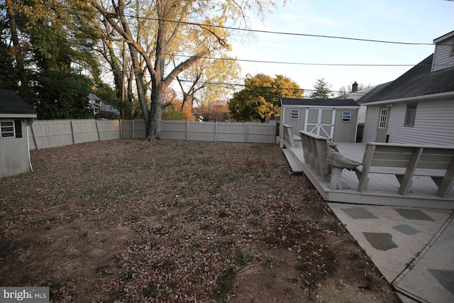 view of yard with a storage shed and a wooden deck