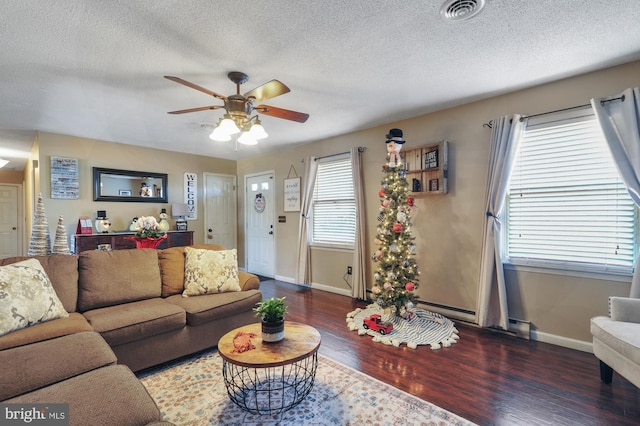 living room featuring a textured ceiling, ceiling fan, and dark hardwood / wood-style floors