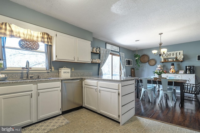 kitchen with dishwasher, white cabinets, a healthy amount of sunlight, and light wood-type flooring