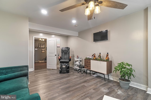 living room featuring hardwood / wood-style floors and ceiling fan