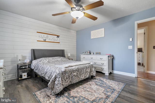 bedroom featuring a textured ceiling, ceiling fan, and dark hardwood / wood-style floors