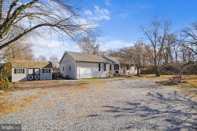 view of front of house featuring covered porch, a garage, and a storage shed