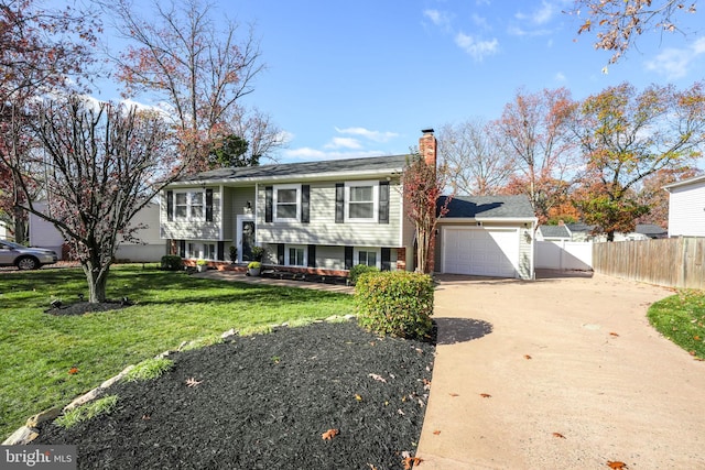 raised ranch with a garage and a front lawn