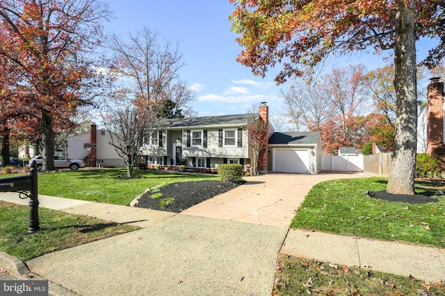 view of front of property with a garage and a front lawn