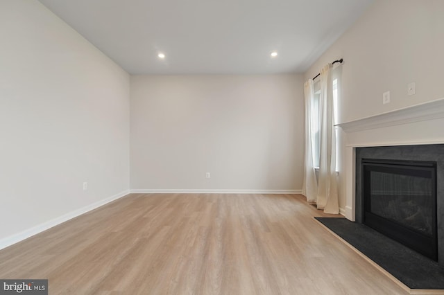 unfurnished living room featuring light hardwood / wood-style floors