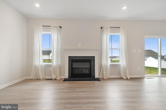 unfurnished living room featuring light hardwood / wood-style flooring