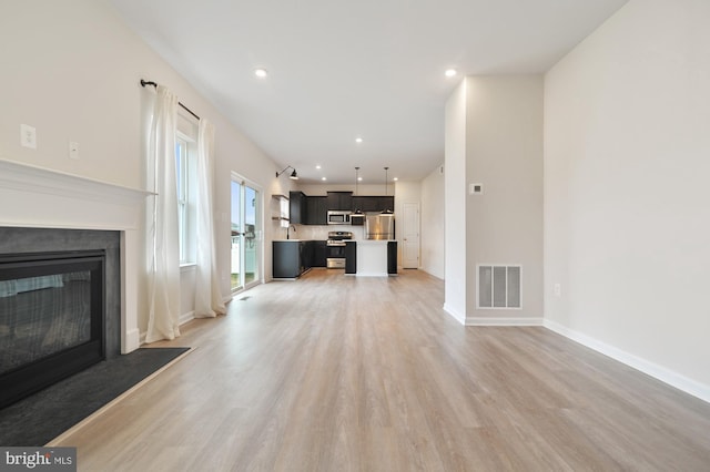 living room with sink and light wood-type flooring