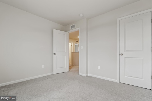 unfurnished bedroom featuring light carpet