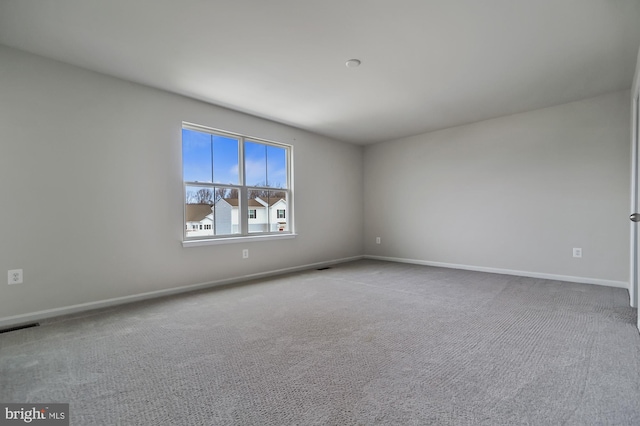 empty room featuring light carpet