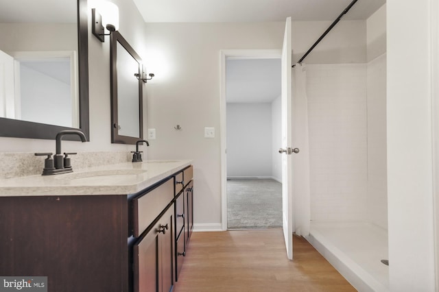 bathroom featuring vanity, hardwood / wood-style flooring, and curtained shower