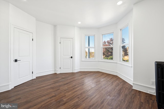 unfurnished living room featuring dark hardwood / wood-style flooring