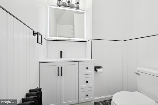 bathroom featuring hardwood / wood-style flooring, vanity, and toilet