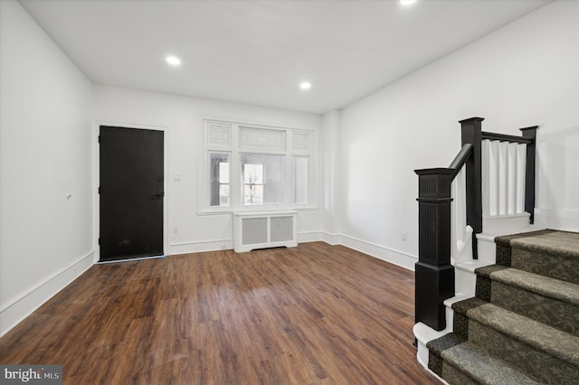 interior space featuring dark hardwood / wood-style flooring and radiator heating unit