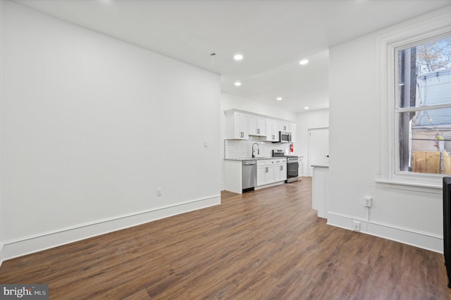 living room featuring dark wood-type flooring and sink