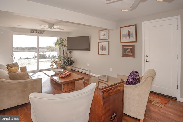 living room featuring ceiling fan, dark hardwood / wood-style flooring, and a baseboard radiator