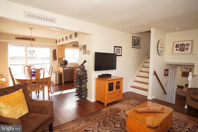 living room with dark hardwood / wood-style floors and a chandelier