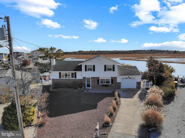 view of front of property featuring a water view and a garage