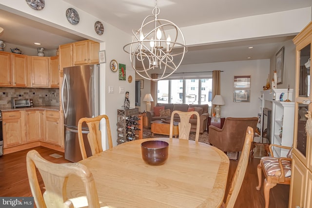 dining area featuring a notable chandelier and wood-type flooring